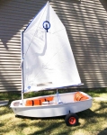 Dynamic Dolly for the Optimist Sailboat.  Made of lightweight aluminum, it makes launching an Opti Sailboat easy.  The wheels on this dolly are 16